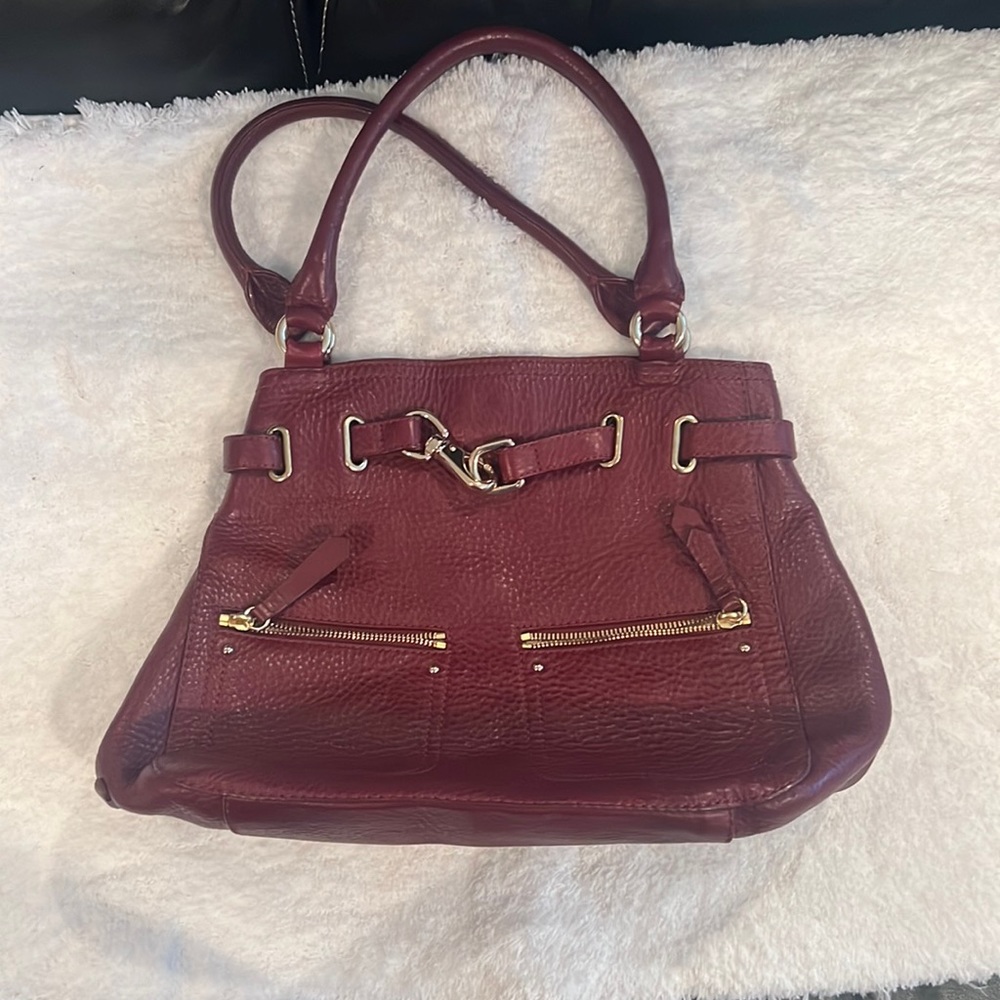 Burgundy Cole Haan purse with multiple pockets inside